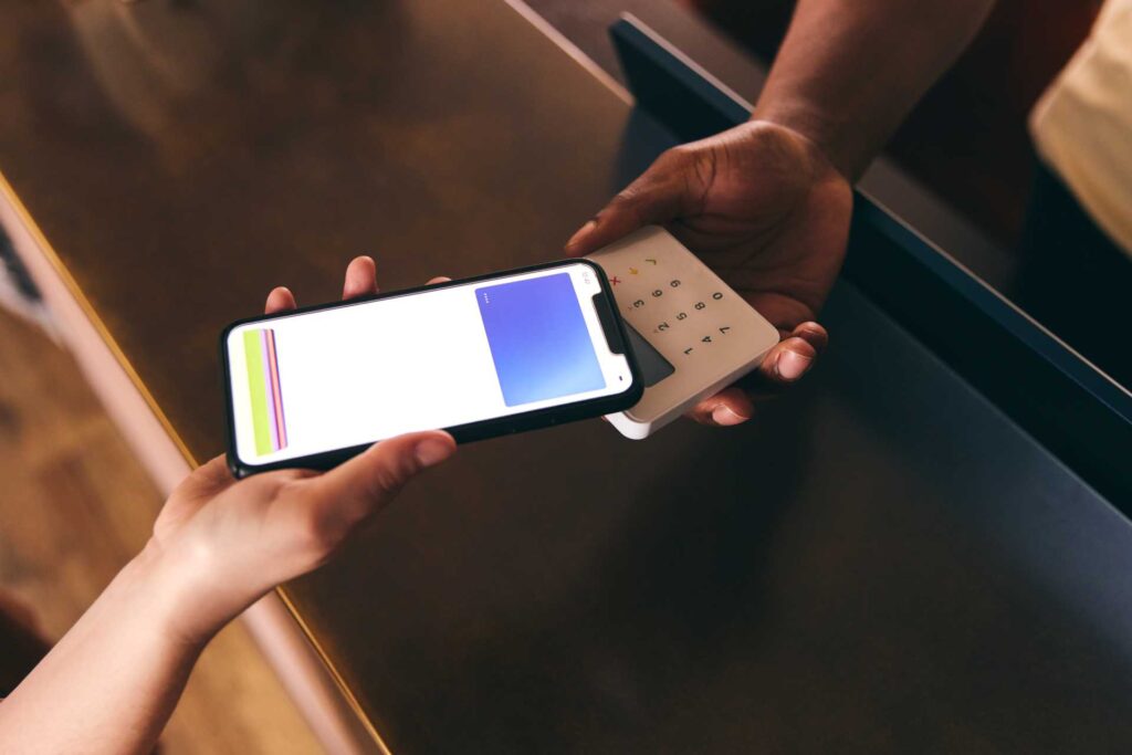 contactless donations charities, A customer tapping their smartphone on an POS to pay