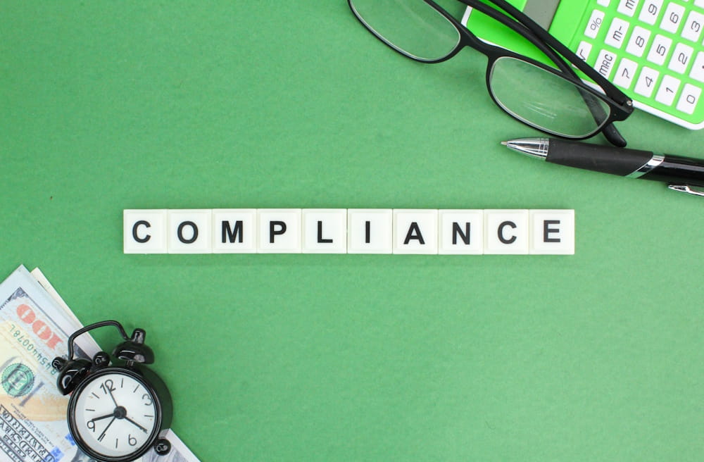 The word compliance spelled with tiles, new 2025 code of fundraising practice